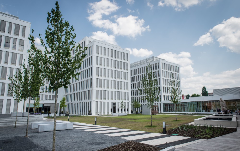 Exterior view of AirPlus's headquarters in Germany, modern building in a green setting.