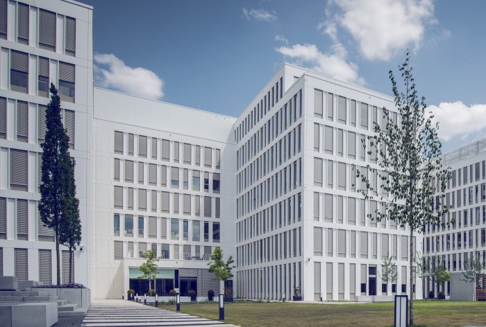 Exterior view of the AirPlus headquarters, a modern building with a glass facade.