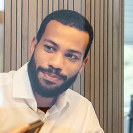 A man shows the payment solutions on his smartphone during a meeting.